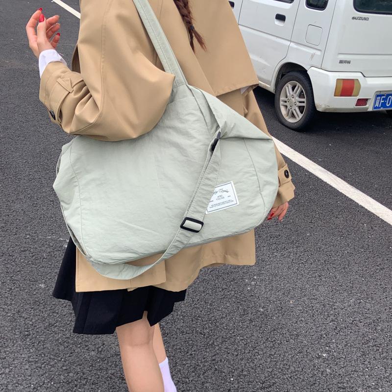 Canvas bag crossbody female Korean version fashionable simple large capacity student class lightweight simple solid color portable shopping bag