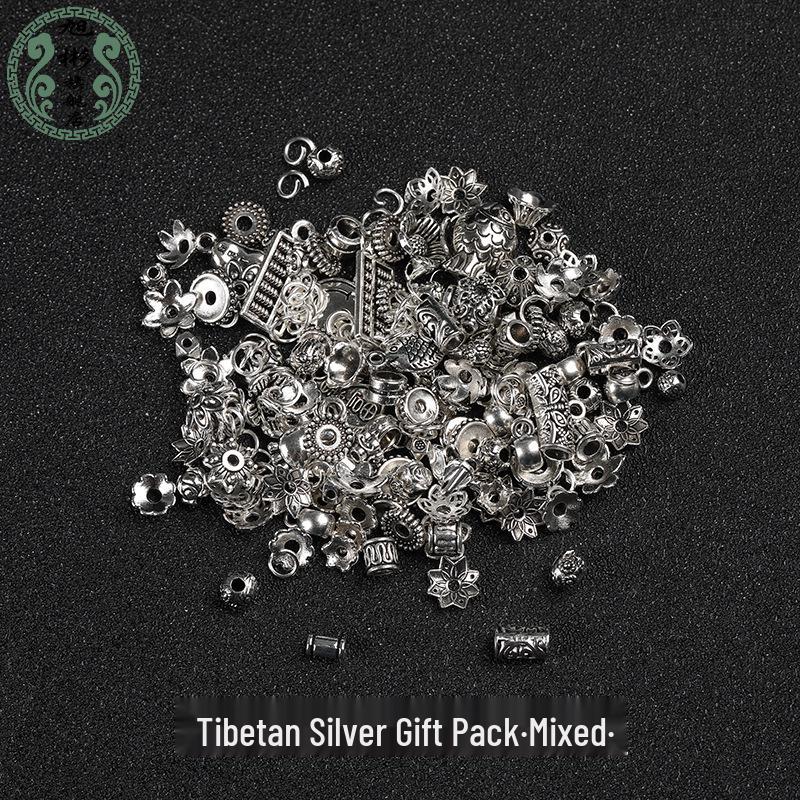 

Tibetan Silver Accessories: Flower Capri, Spacer Beads, Fish Pendant, and Handmade Braided Bracelet Set.