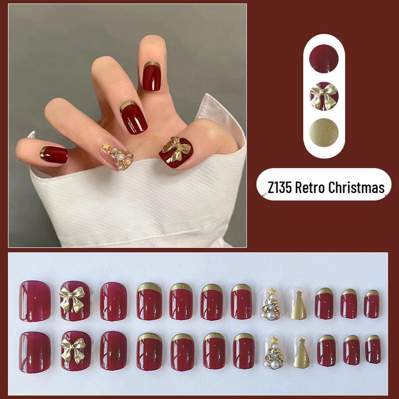 

Бордовые накладные ногти с золотой окантовкой, с дизайном бантика и рождественской елки
