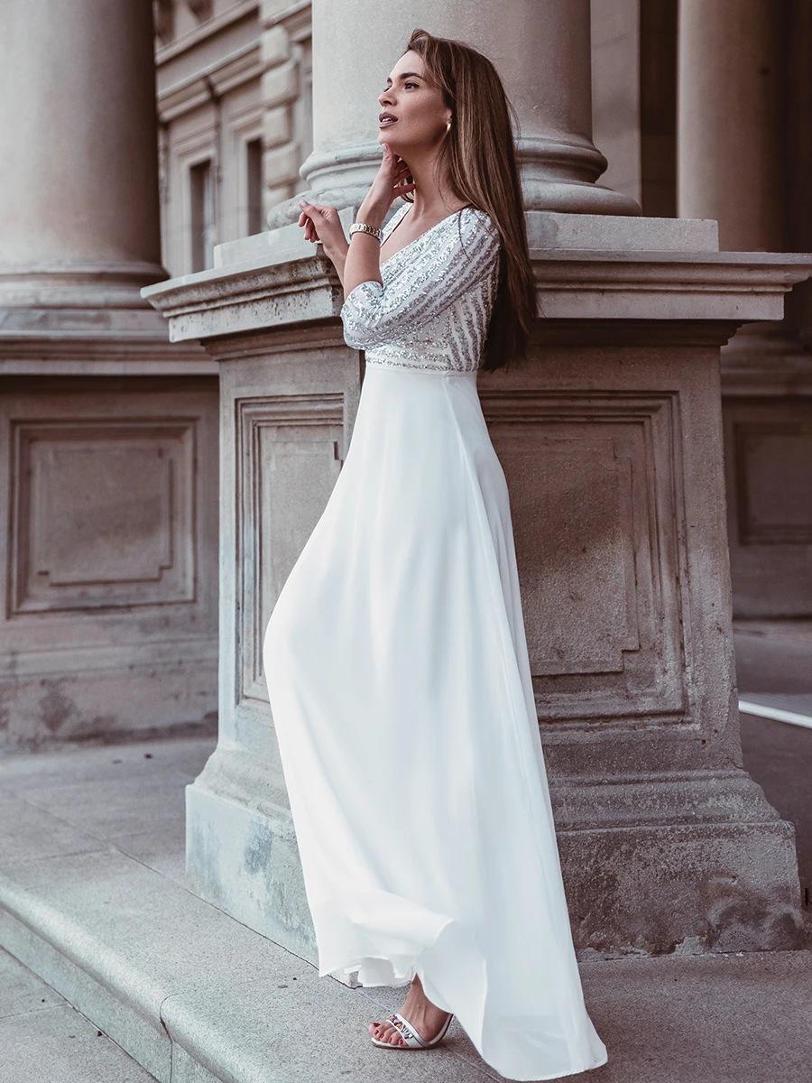 

Елегантна вечірня шифонова сукня великого розміру з V-подібним вирізом, рукавами до ліктя та спідницею, що розвівається, прикрашена паєтками. Small білий