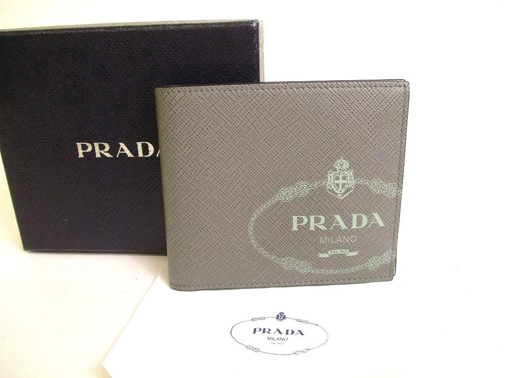 

Автентичний шкіряний гаманець PRADA Grey Saffiano з принтом на дві купюри №a256 відремонтований