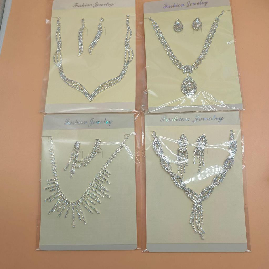 Luxury Diamond Jewelry Set: Shimmering Necklace, Tassel Earrings, Bracelet, and Ring for Brides