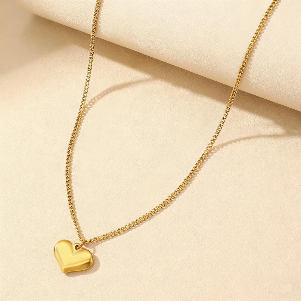 Gold Stainless Steel Cross Necklace - Light Luxury High-End Collarbone Chain with Gold Heart.