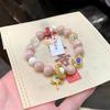 Bracelet en perles céramiques gris-rose avec cœur blanc et mantra à six caractères, accents dorés émaillés pour la chance