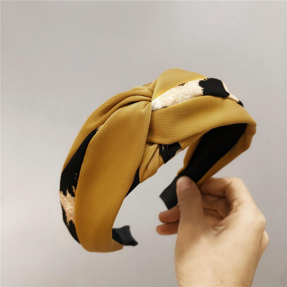 A unique leopard print color-blocked knotted headband with a goddess-like charm and a trendy fabric wide headband