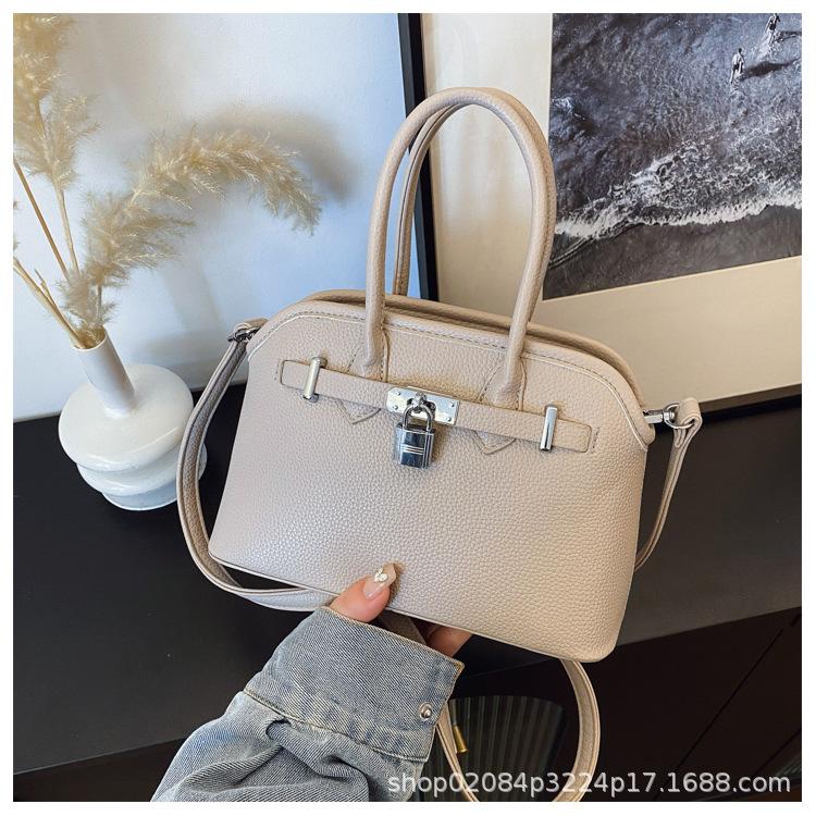 

2025 новая женская однотонная сумка через плечо с узором личи, темпераментная, нишевая, универсальная, для通勤, портативная, мессенджер