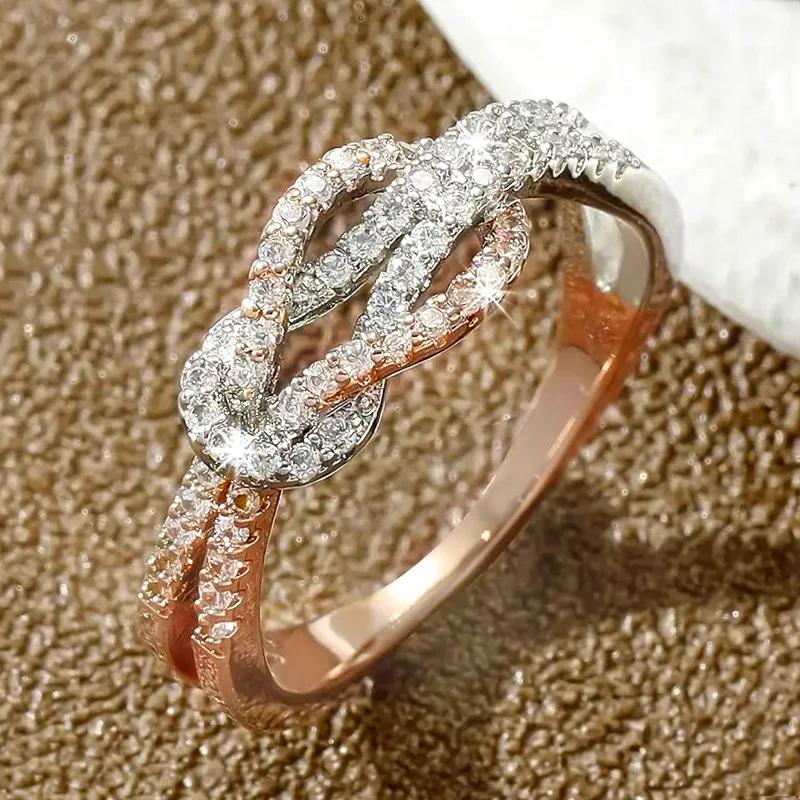 

2026 New European and American Two Tone Elegant Ring for Women s Personality Micro Inlaid Zircon Fashion Knot Design Zircon 10