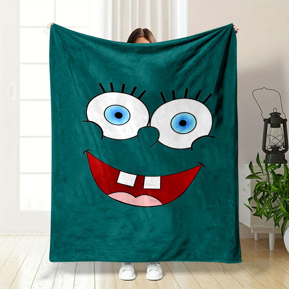 Bright cartoon face with large blue eyes, wide smile, and prominent teeth. for all seasons blanket lunch break throw gift