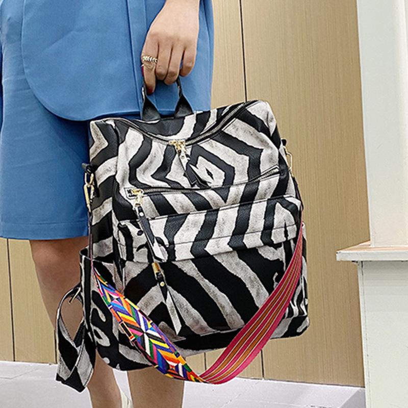 Neuer PU Retro Rucksack mit großer Kapazität für Reisen, Kuhmuster, schlichter britischer Stil, schräg über die Schulter tragbar, für Damen