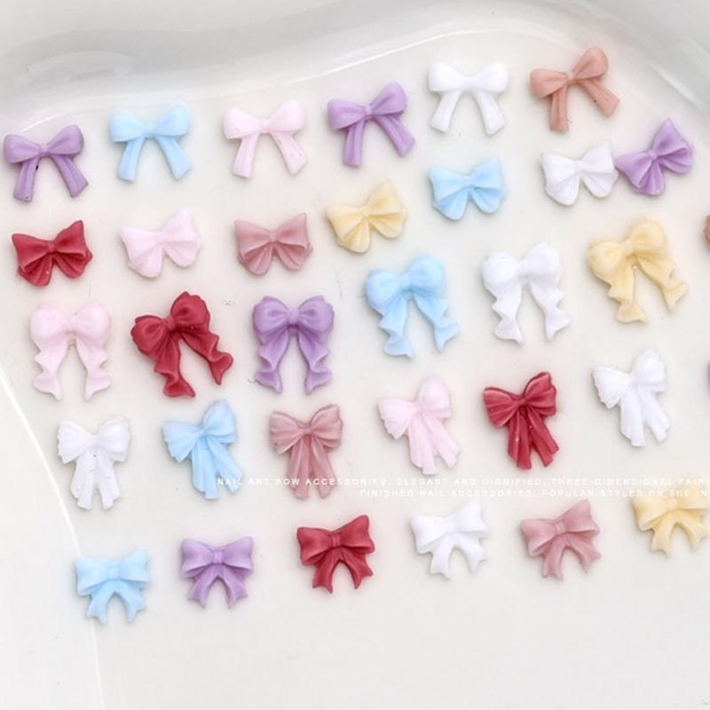 50 Stück Schleifen Nagelanhänger Einfache Schleife Nagelkunst Dekorationen Schleifen Designs Nagelzubehör Harzschleifen Nagel Strasssteine Geschenke