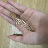 Women's Gold-Plated Copper Bracelet with Rhinestones and Twisted Knot Design