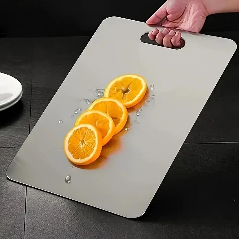 Premium double - sided titanium chopping board. Food - grade steel, durable, easy - clean, rustproof. Ergonomic handle, sleek look, great for kitchen.