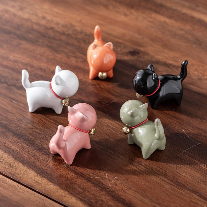 Eine kleine niedliche Katze im chinesischen Stil als Teehaustierfigur mit einem Keramik-Katzenpinselständer