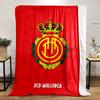 A crowned emblem with yellow circular patterns on a red background. for all seasons blanket lunch break throw gift