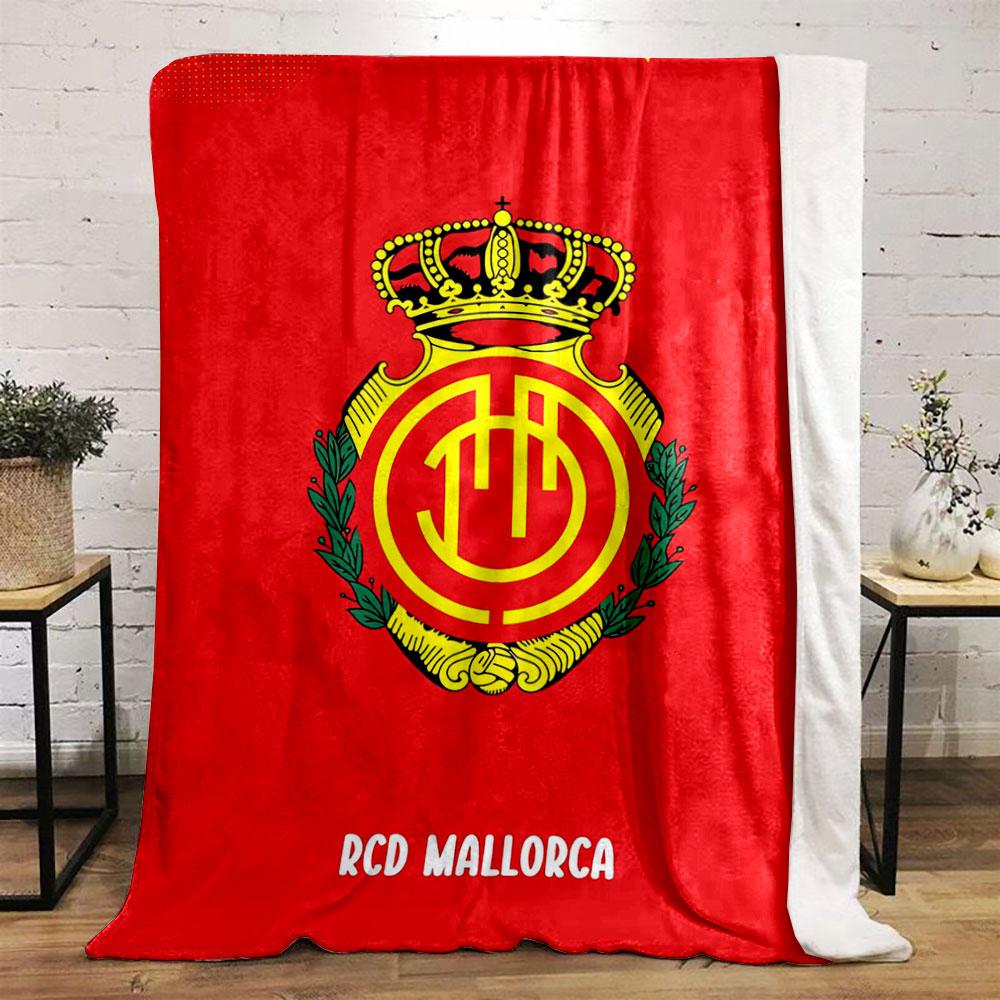 A crowned emblem with yellow circular patterns on a red background. for all seasons blanket lunch break throw gift