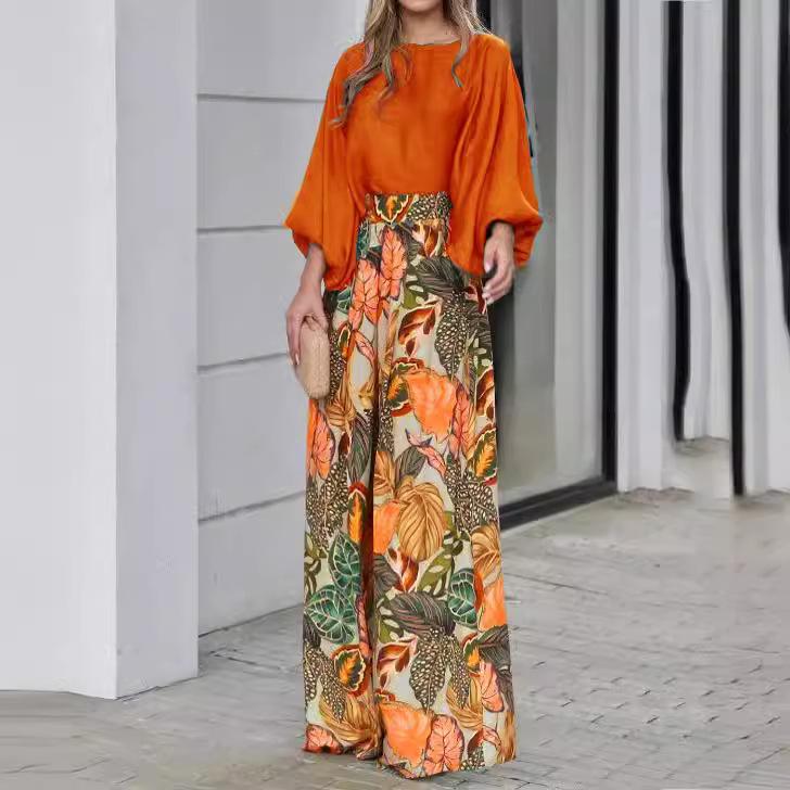 

Женский комплект из двух предметов: однотонный свободный топ с рукавами-фонариками, широкие брюки с принтом XL оранжевый