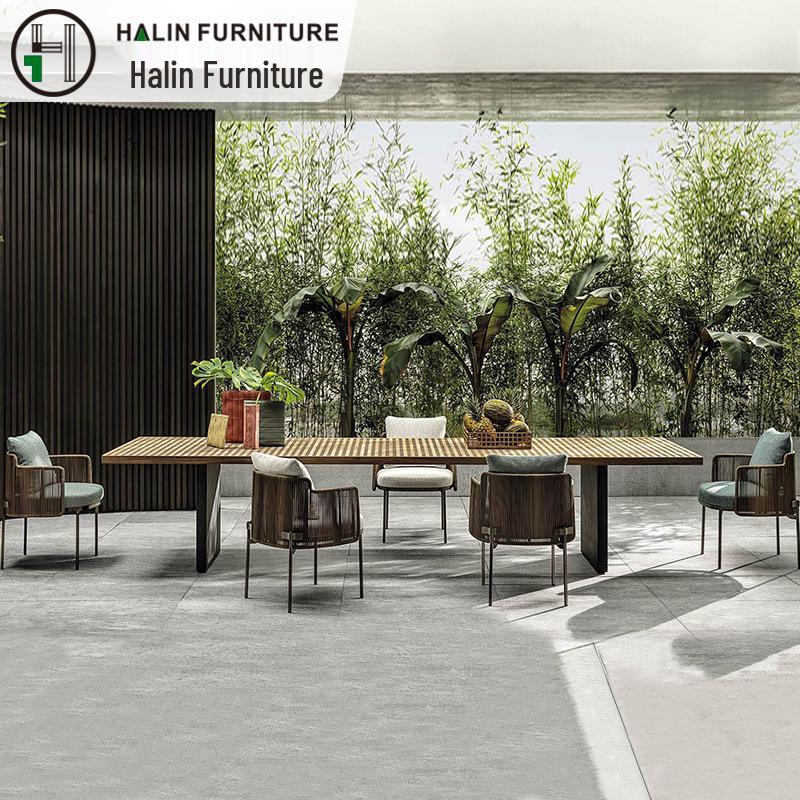 Outdoor Rattan Dining Set: Long Table with Casual Woven Chairs for Garden, Terrace, or Courtyard.