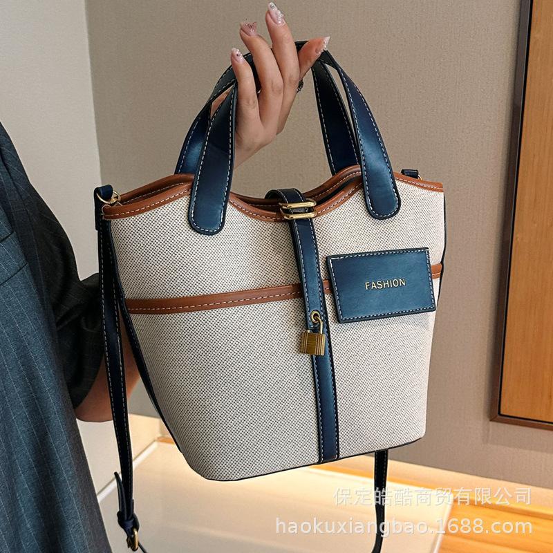 Canvas niche contrasting color handbag women's 2025 summer new Korean fashion shoulder messenger bag versatile bucket bag