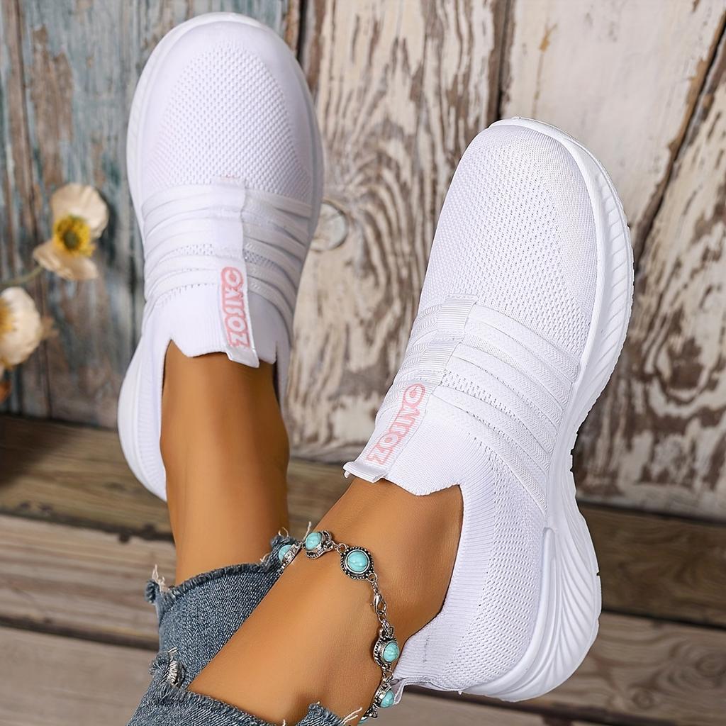 The Lady Wears Slip-On Casual Sports Shoes, Featuring a Breathable Mesh Design with Pastel Stripes, Suitable for Tennis And Comfortable
