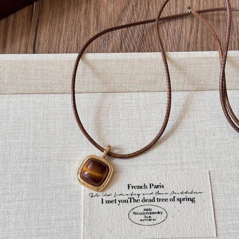 

Brown leather rope Tiger s eye stone necklace Women s light luxury sweater chain Vintage Maillard design pull necklace