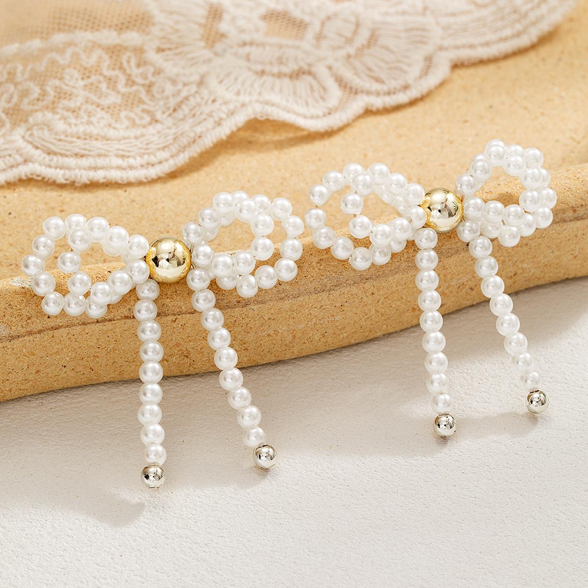 

Fashionable retro black bow bead earrings with personalized elegance, imitation pearl bow earrings