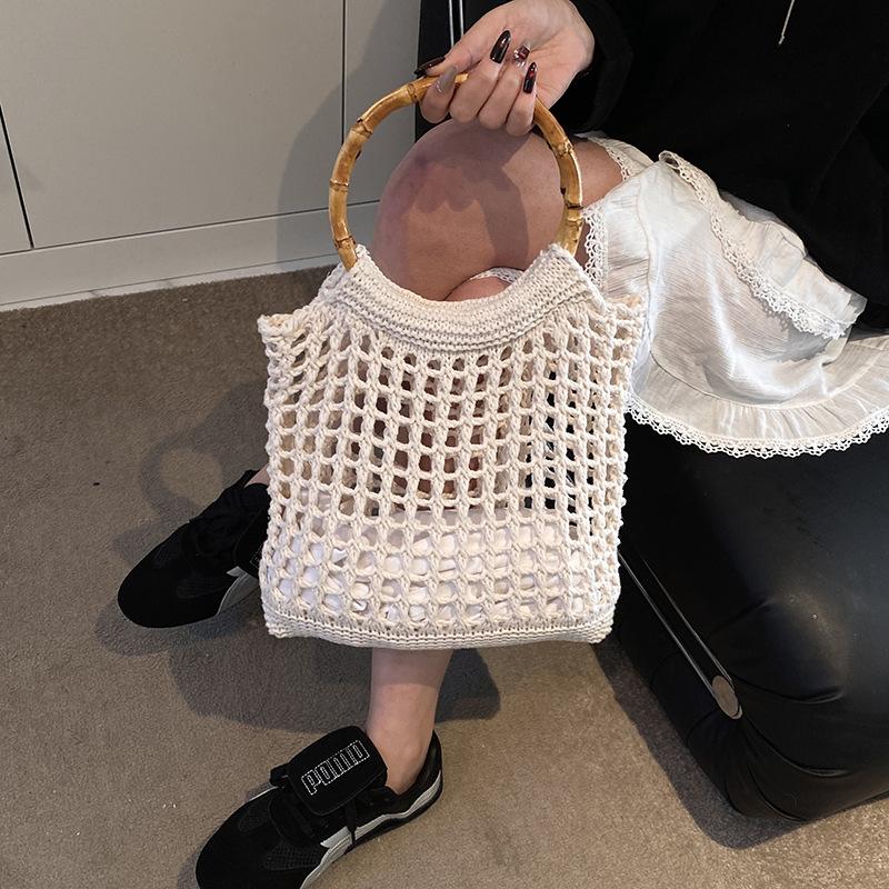 Hand carry woven bag women's Korean version ins fashion simple casual straw bag 2025 niche high-end hollow women's bag