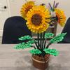A Holiday Gift Given To Oneself As a Potted Indoor Decoration of Building Blocks, Simulated Flowers, and Sunflowers