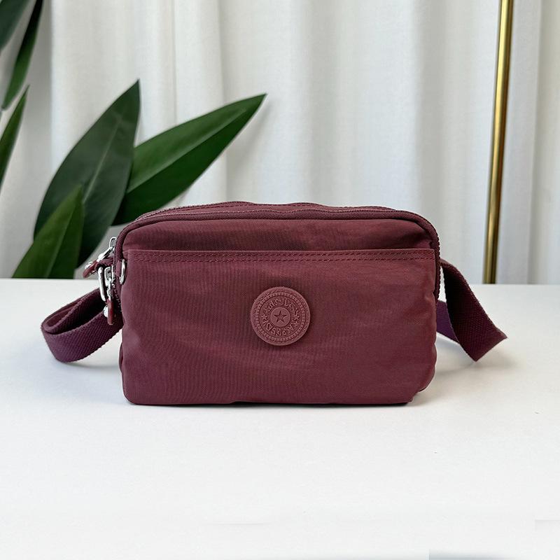

2025 new crossbody multi-pocket cloth bag lightweight shoulder anti-splashing small bag women s casual multi-compartment portable bag красный