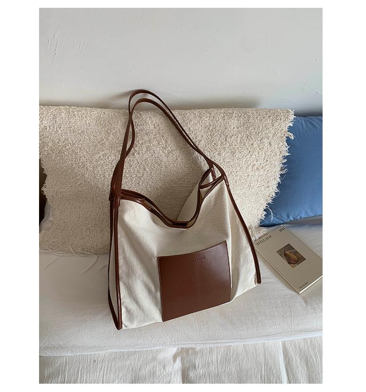 

Fashion retro splicing tote bag women s 2025 new large-capacity canvas shoulder bag casual commuter armpit bag коричневый