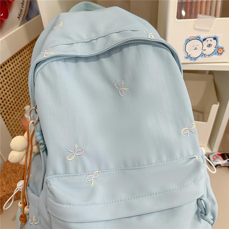 Zaino scolastico carino con ricamo a fiocco, tasca frontale, manico superiore, zainetto casual per uso quotidiano
