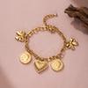 Golden Tone Stainless Steel Bow and Heart Charm Bracelet with Coin Accents for Women