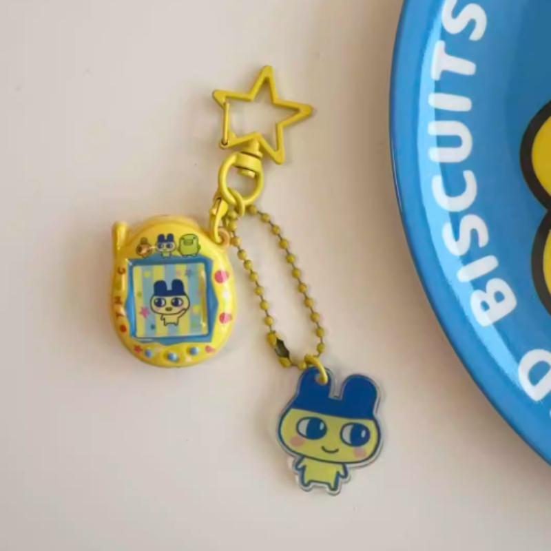 

Cartoon Tamagotchi Charms Mametchi Lovelin Kuhcipatchi Cute Pendant Keychain Bag Charm Collectible Decoration Kid Birthday Gifts Carry Mini