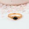 Black Onyx Marquise Gold Ring: Elegant vintage-style jewelry with a dark navette gemstone and ornate filigree band.