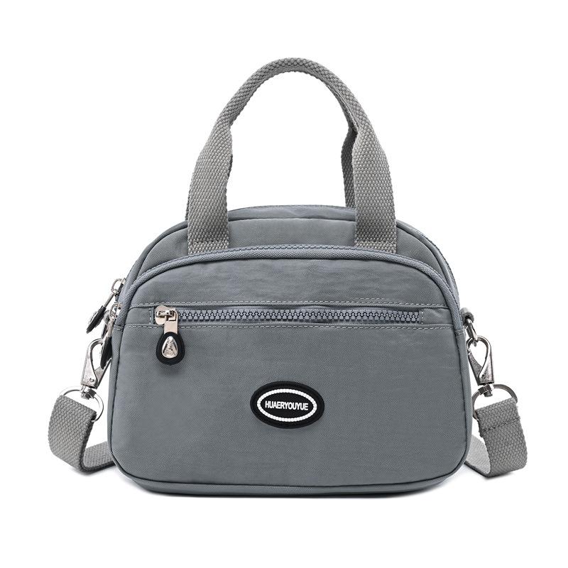 

2024 летняя новая женская сумка через границу, модная портативная сумка через плечо, легкая потертая нейлоновая повседневная сумка серый/серебряный