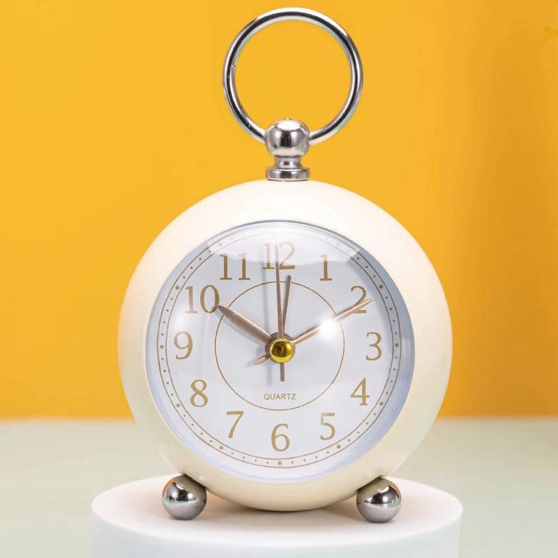Silent Metal Alarm Clock with Night Light and Gold Stamped Spherical Face - Perfect for Students and Children.