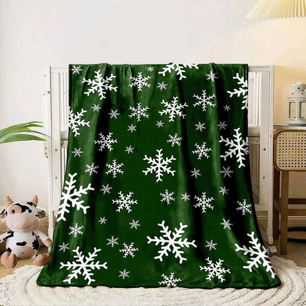 White snowflakes scattered on a dark green background. for all seasons blanket lunch break throw gift 80cm x 120cm