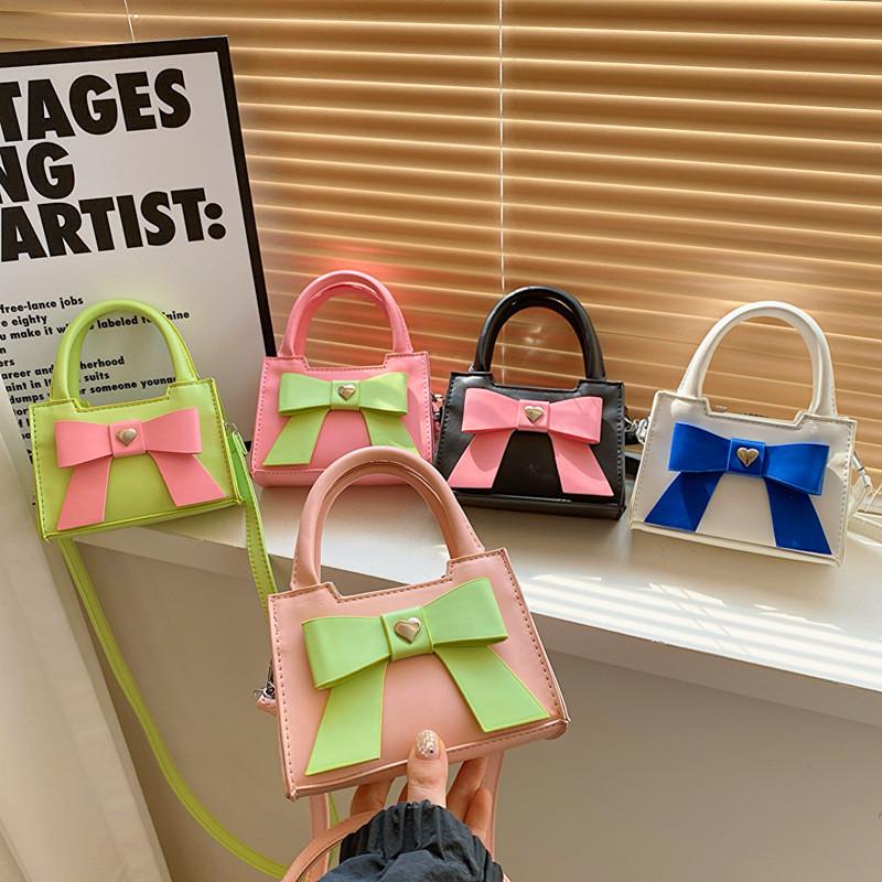 Stylish Korean Toddler Shoulder Bag For Kids Featuring Chic Color Block Design And Sweet Bow Detail