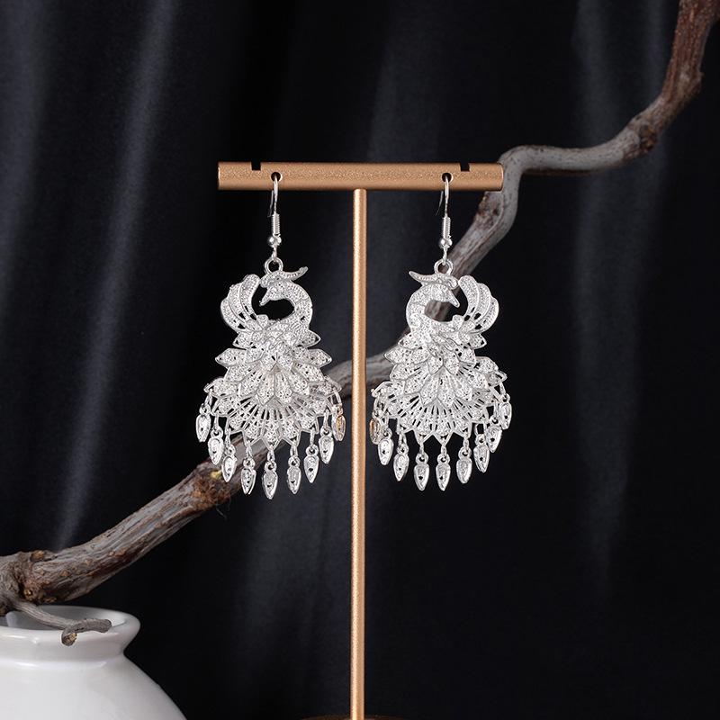 Bohemian Ethnic Miao Silver Tassel Earrings with Butterfly, Peacock, and Flower Design for Women – Long Dangle Jewelry for Travel Photos.
