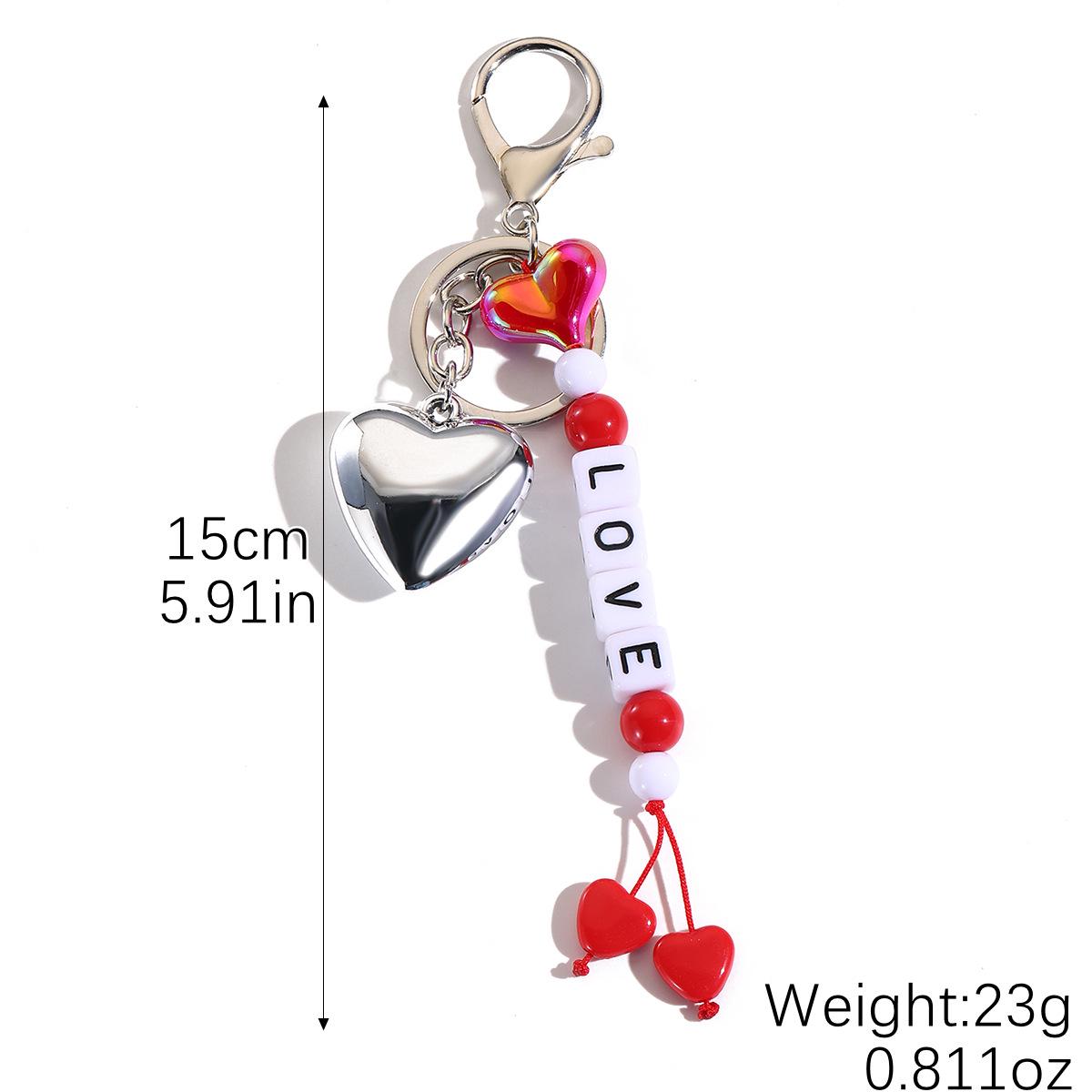 Ключница-брелок  Улыбающееся лицо  с кисточкой, сердцем и бусинами