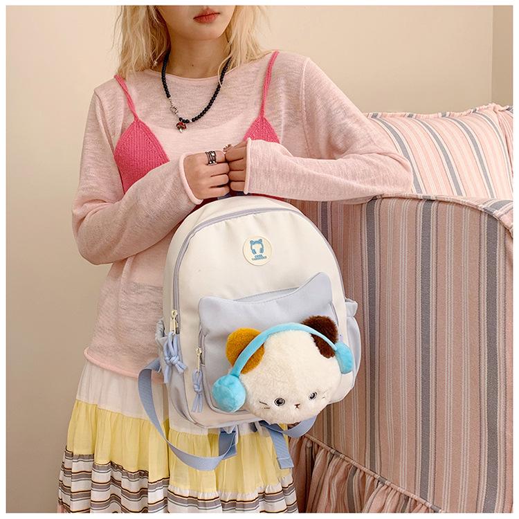 Cute Cartoon Trendy Backpack: Large Capacity, Lightweight, Versatile Travel/School Bag with Earphone and Doll Holder.