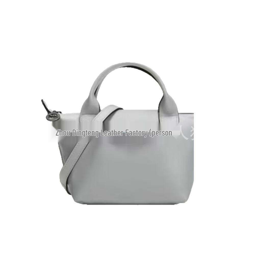 Hochwertige Mini-Knödeltasche aus Nappaleder mit Drachenprägung, Vielseitig für den Weg zur Arbeit, zum Tragen in der Hand, über der Schulter, mit verstellbarem Crossbody-Riemen.