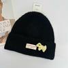 Three-dimensional puppy patch knitted hat female, soft waxy vertical pattern curled edge cold hat, autumn and winter warm wool hat