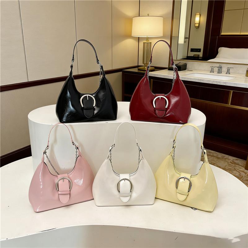 Solid color crescent-shaped hobo bag with metal D-ring embellishment, elegant underarm bag, versatile women's handbag for dates and everyday wear.