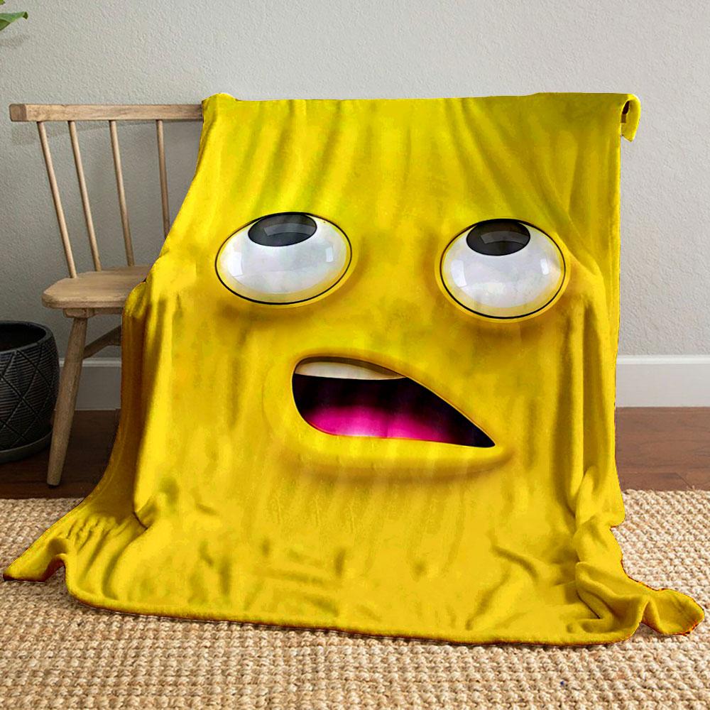 Bright yellow cartoon face with large eyes and an open mouth showing pink. for all seasons blanket lunch break throw gift