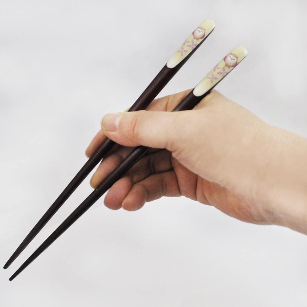 A pair of lacquered chopsticks for featuring a lucky charm design and a smiling owl presented in a paulownia wood Made in couples, motif, box. Japan.