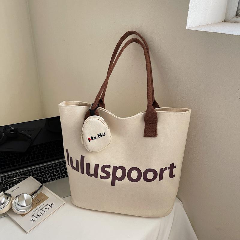 

Niche solid color canvas bag 2025 autumn new casual letter shoulder bag commuting large capacity student tote bag no pendant темно-коричневого кольору