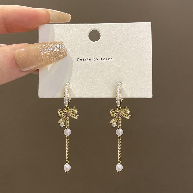 Bow pearl fringed earrings women s high-end temperament super fairy long ear buckles European and American retro personalized ear jewelry
