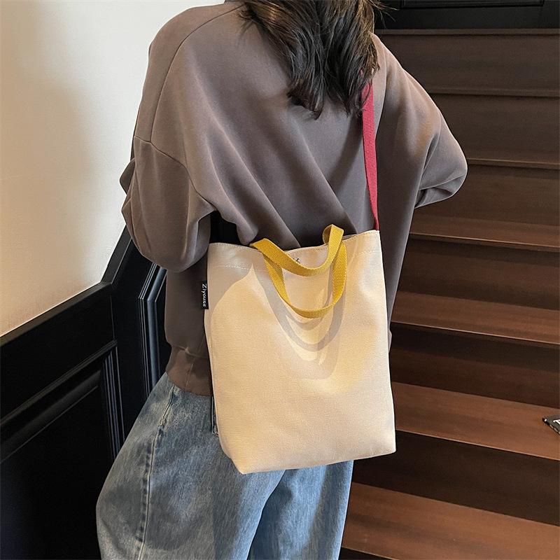 Portable shoulder tote cloth bag women's new simple commuting design sense niche large-capacity leisure bucket bag