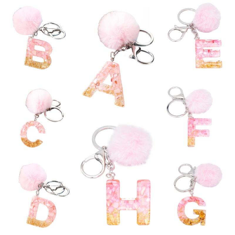 Modischer Schlüsselanhänger mit Plüschball und englischen Buchstaben Kreatives Autozubehör