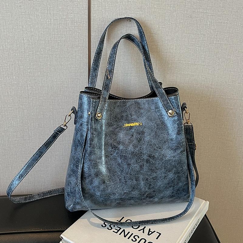 Beliebte Taschen für Frauen Große Kapazität Neue Retro-Mode Breitbandige Einzel-Schulter Crossbody-Tasche Hand-Eimer-Tasche